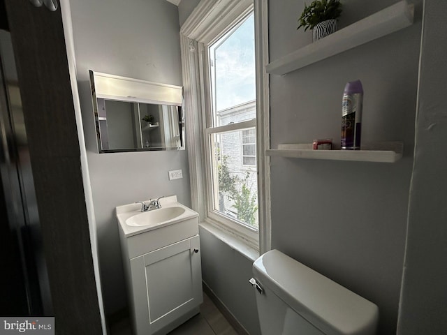 342 S 4th St, Reading, PA 19602 - half bath with vanity, toilet, and tile patterned floors
