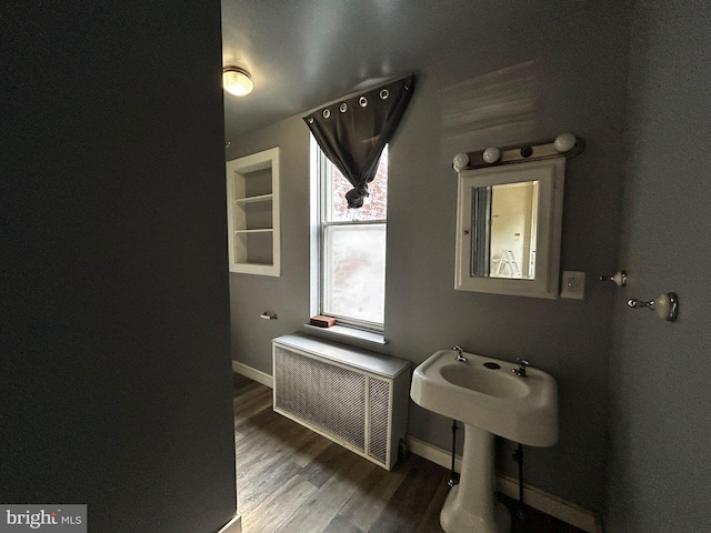 342 S 4th St, Reading, PA 19602 - bathroom with radiator heating unit, wood finished floors, and baseboards