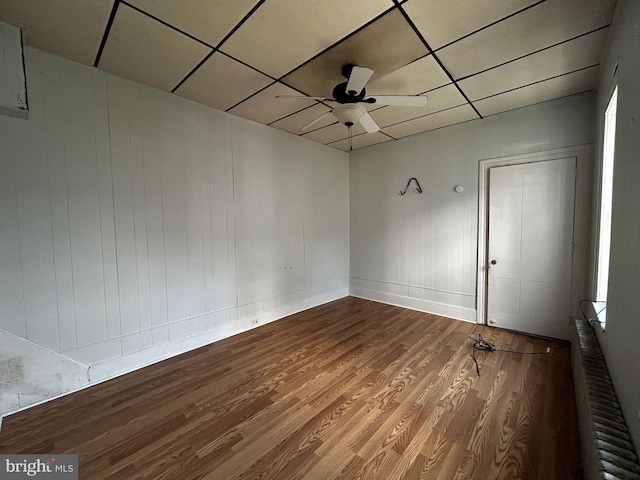 342 S 4th St, Reading, PA 19602 - empty room featuring wood finished floors, a ceiling fan, a drop ceiling, baseboards, and radiator heating unit