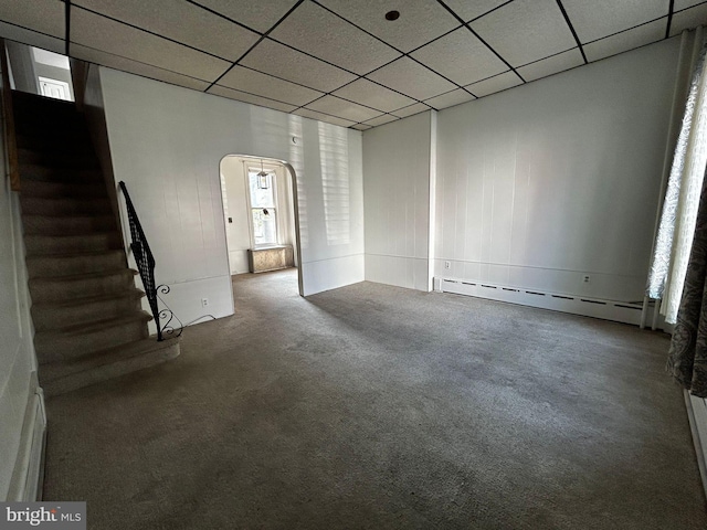 342 S 4th St, Reading, PA 19602 - empty room with a baseboard radiator, arched walkways, carpet, stairway, and a paneled ceiling