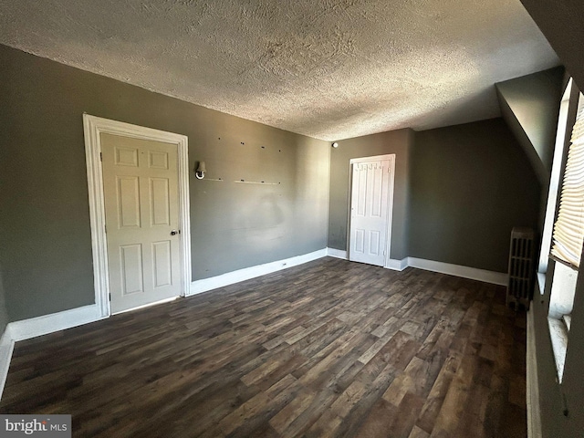 342 S 4th St, Reading, PA 19602 - bonus room featuring dark wood finished floors, a textured ceiling, radiator, and baseboards