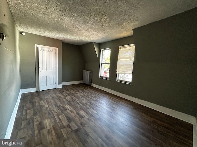 342 S 4th St, Reading, PA 19602 - unfurnished bedroom featuring radiator heating unit, dark wood finished floors, baseboards, a textured ceiling, and a closet