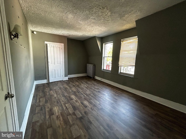 342 S 4th St, Reading, PA 19602 - bonus room with radiator, dark wood-style floors, baseboards, and a textured ceiling