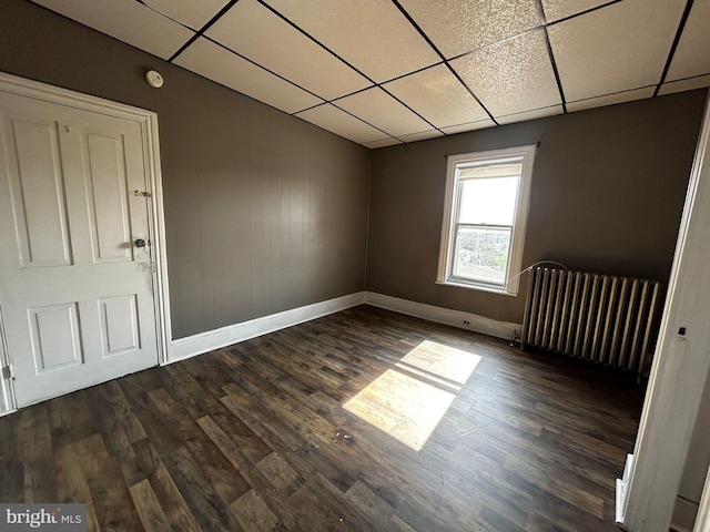 342 S 4th St, Reading, PA 19602 - unfurnished room with radiator, a drop ceiling, baseboards, dark wood-style flooring, and a smoke detector