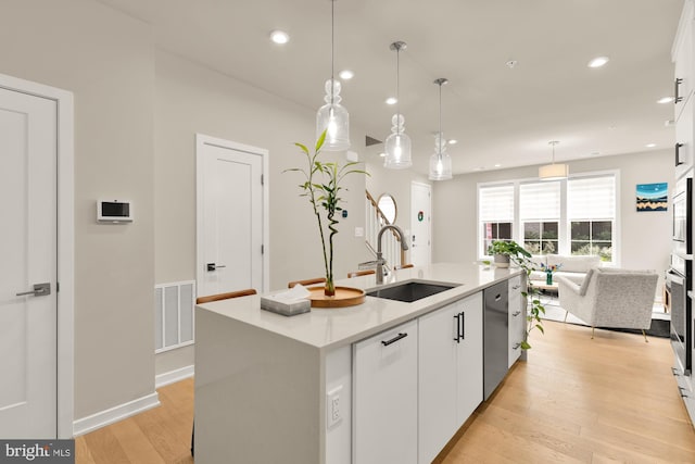 7458 Backett Wood Ter Unit 401, Mclean, VA 22102 - kitchen with a sink, dishwasher, white cabinets, recessed lighting, and light wood finished floors