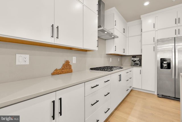 7458 Backett Wood Ter Unit 401, Mclean, VA 22102 - kitchen featuring appliances with stainless steel finishes, wall chimney range hood, light countertops, recessed lighting, and white cabinetry