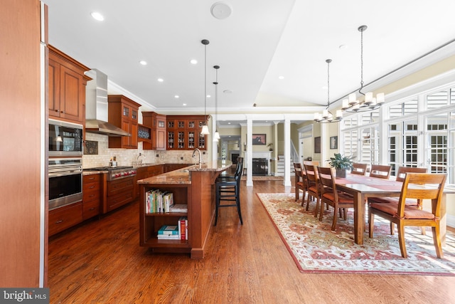 4491 Province Line Rd, Princeton, NJ 08540 - kitchen featuring stainless steel appliances, wall chimney exhaust hood, open shelves, a kitchen breakfast bar, and a chandelier