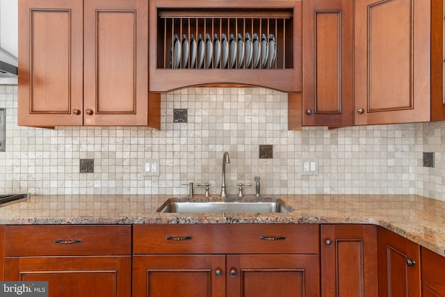 4491 Province Line Rd, Princeton, NJ 08540 - kitchen featuring a sink, brown cabinets, light stone counters, and backsplash