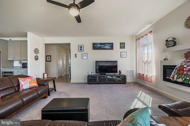 126 Lennox Ct, Camden Wyoming, DE 19934 - living area with ceiling fan, a glass covered fireplace, carpet flooring, and baseboards