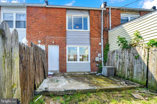 7952 Eastdale Rd, Baltimore, MD 21224 - back of property featuring brick siding, a patio area, central air condition unit, and a fenced backyard
