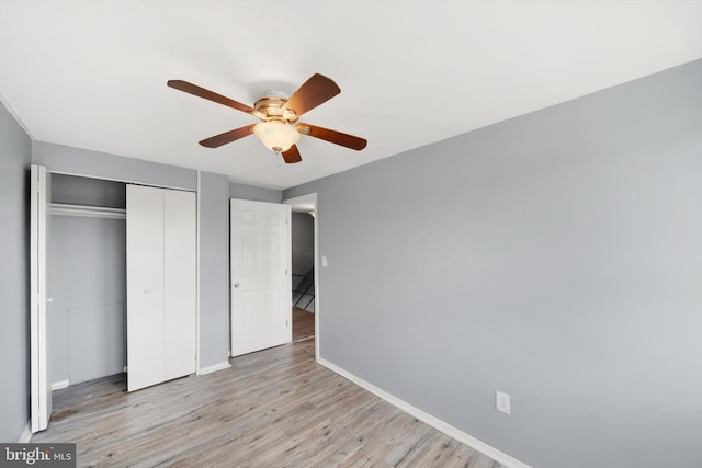 7952 Eastdale Rd, Baltimore, MD 21224 - unfurnished bedroom featuring baseboards, a closet, light wood-style floors, and a ceiling fan