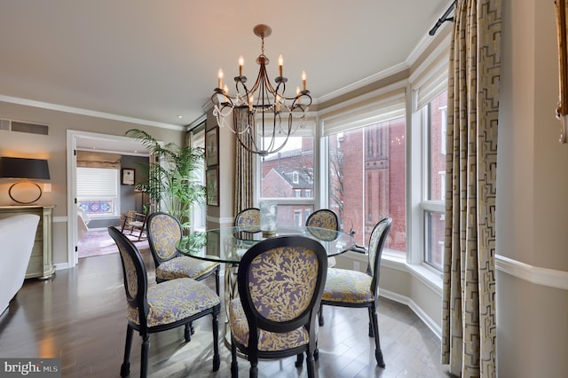 110 N Duke St Unit 201, Lancaster, PA 17602 - dining room featuring a chandelier, dark wood-type flooring, healthy amount of natural light, baseboards, and crown molding