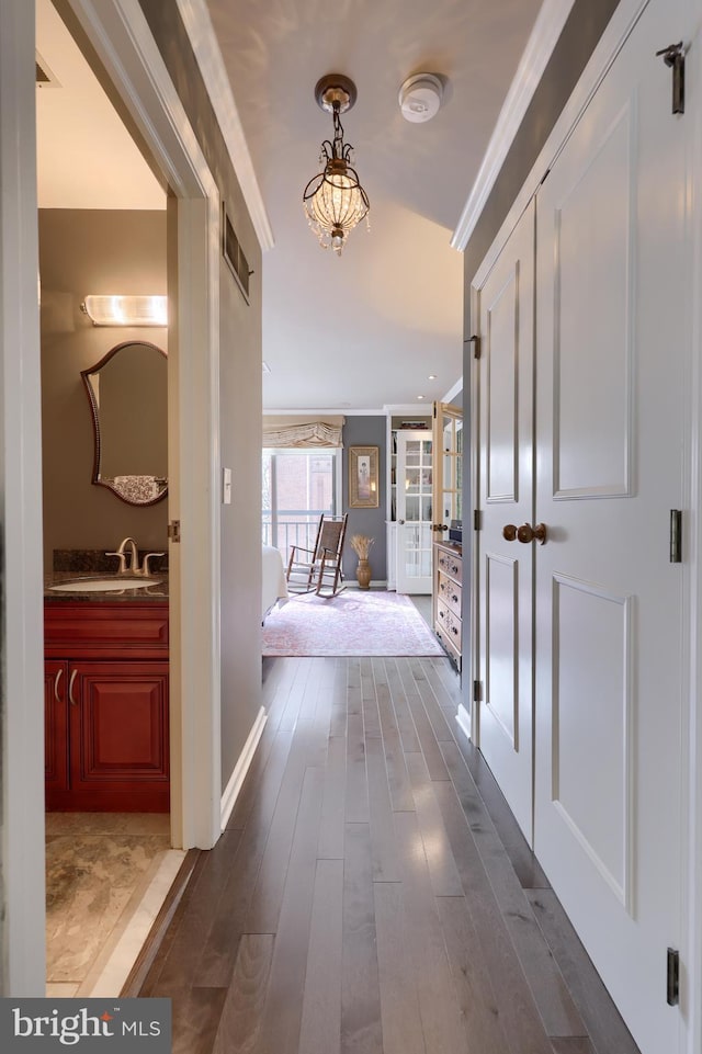 110 N Duke St Unit 201, Lancaster, PA 17602 - hallway featuring dark wood-style flooring, a sink, ornamental molding, and baseboards