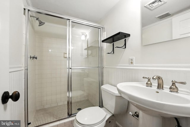 12134 Stirrup Rd, Reston, VA 20191 - bathroom featuring a shower stall, a wainscoted wall, and ornamental molding