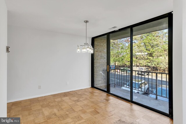 523 N Armistead St Unit 102, Alexandria, VA 22312 - empty room featuring expansive windows, a chandelier, and baseboards