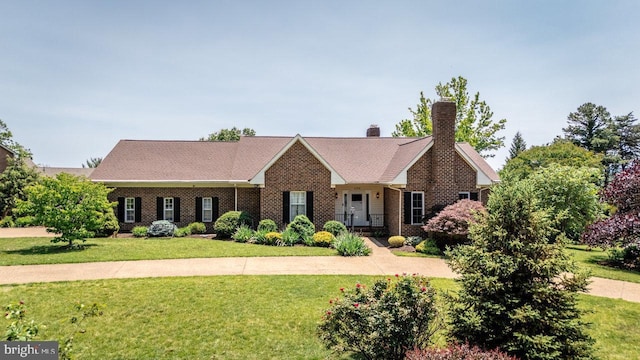 1492 Cumberland Dr, Rockingham, VA 22801 - view of front of house featuring a front lawn, a chimney, and brick siding