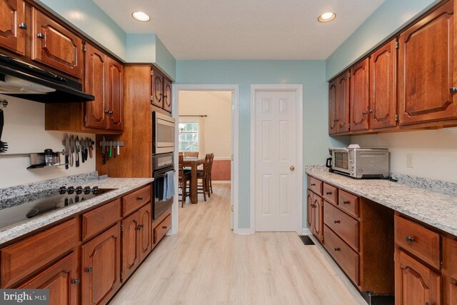 1492 Cumberland Dr, Rockingham, VA 22801 - kitchen with black appliances, light wood-style flooring, brown cabinetry, recessed lighting, and ventilation hood