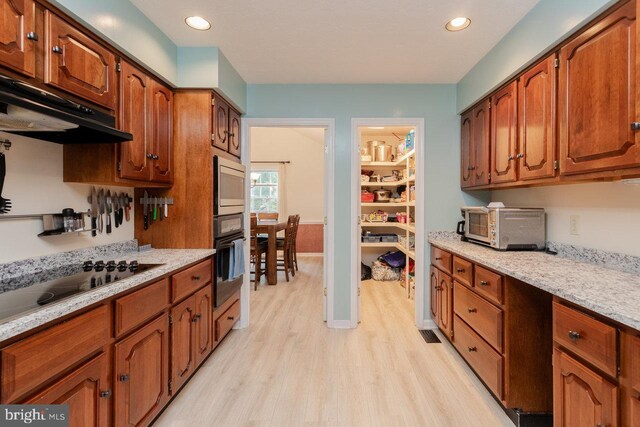 1492 Cumberland Dr, Rockingham, VA 22801 - kitchen featuring black appliances, light wood-style floors, brown cabinetry, recessed lighting, and range hood