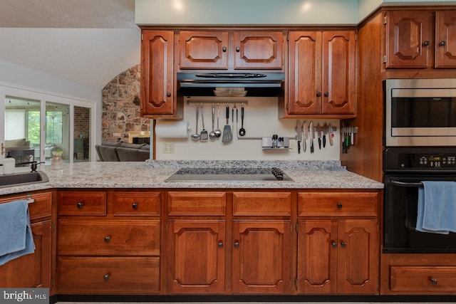 1492 Cumberland Dr, Rockingham, VA 22801 - kitchen with black appliances, range hood, vaulted ceiling, brown cabinetry, and a sink