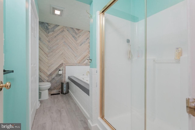 1492 Cumberland Dr, Rockingham, VA 22801 - bathroom featuring toilet, wood finished floors, a shower stall, and a garden tub