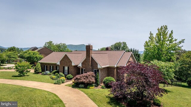 1492 Cumberland Dr, Rockingham, VA 22801 - view of front of house featuring a front lawn, a chimney, and brick siding