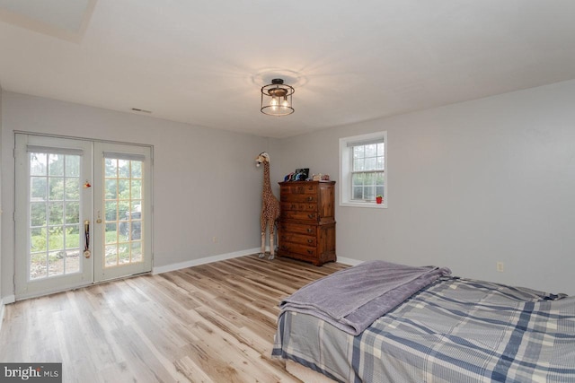 1492 Cumberland Dr, Rockingham, VA 22801 - bedroom featuring french doors, access to exterior, baseboards, and light wood-style flooring