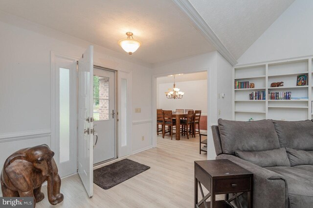 1492 Cumberland Dr, Rockingham, VA 22801 - entrance foyer with light wood finished floors, a chandelier, and a textured ceiling