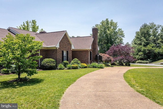 1492 Cumberland Dr, Rockingham, VA 22801 - view of front facade featuring a front yard, a chimney, brick siding, and a shingled roof