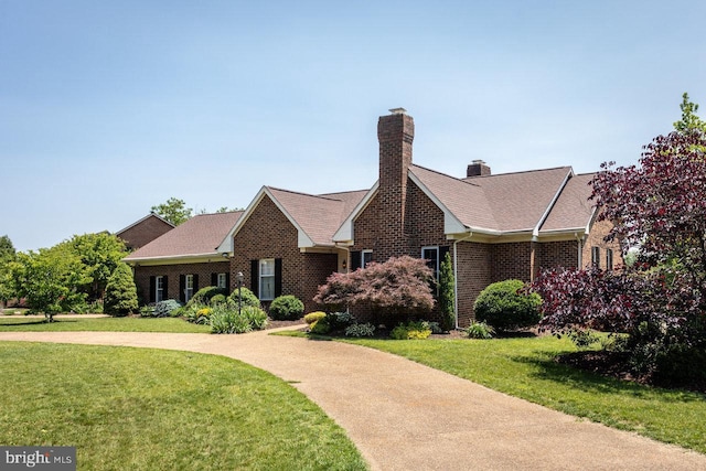 1492 Cumberland Dr, Rockingham, VA 22801 - view of front of property featuring brick siding, a front lawn, a chimney, and roof with shingles