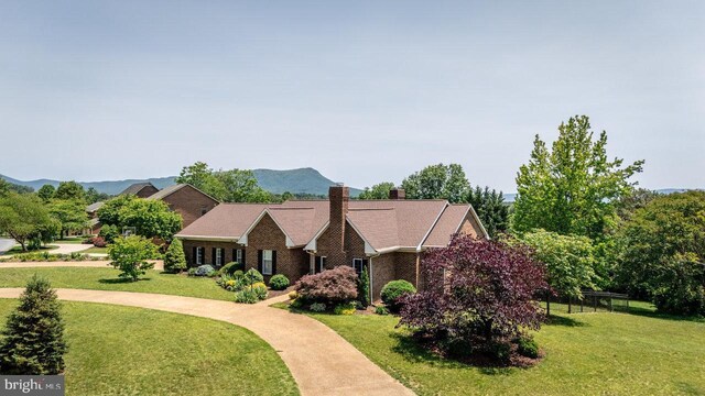 1492 Cumberland Dr, Rockingham, VA 22801 - view of front of property with a chimney, a front lawn, and brick siding