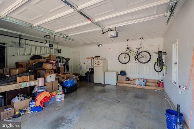 1492 Cumberland Dr, Rockingham, VA 22801 - garage with freestanding refrigerator, refrigerator, and a garage door opener