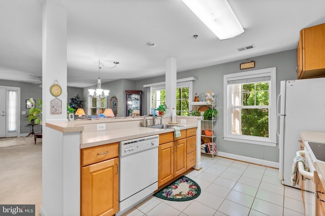 9718 Winery Ct Unit 9718, Gaithersburg, MD 20879 - kitchen with white appliances, a sink, light countertops, baseboards, and a chandelier