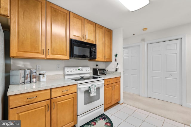 9718 Winery Ct Unit 9718, Gaithersburg, MD 20879 - kitchen with black microwave, white range with electric cooktop, light countertops, light carpet, and light tile patterned flooring