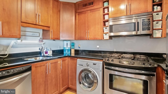 7333 New Hampshire Ave Unit 800, Takoma Park, MD 20912 - kitchen with washer / dryer, stainless steel appliances, open shelves, a sink, and brown cabinetry