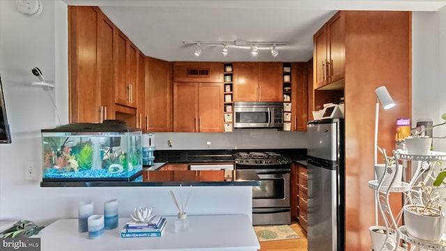 7333 New Hampshire Ave Unit 800, Takoma Park, MD 20912 - kitchen featuring stainless steel appliances, open shelves, brown cabinets, a peninsula, and dark countertops