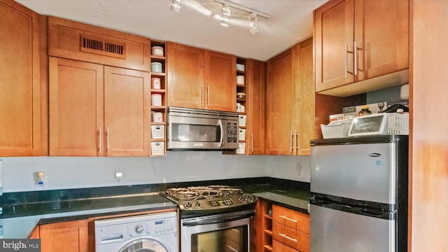 7333 New Hampshire Ave Unit 800, Takoma Park, MD 20912 - kitchen with stainless steel appliances, washer / dryer, open shelves, dark countertops, and track lighting