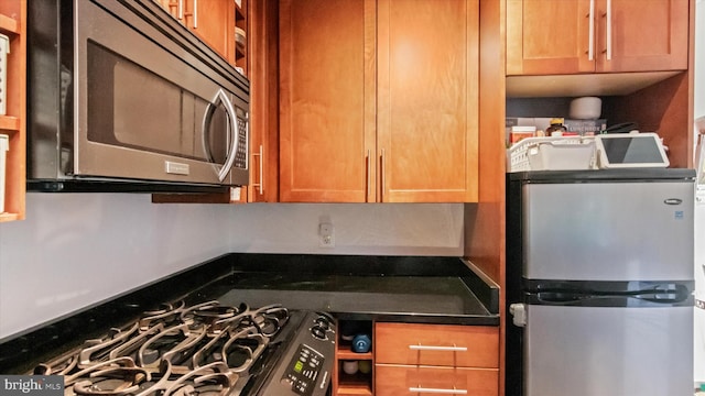 7333 New Hampshire Ave Unit 800, Takoma Park, MD 20912 - kitchen with stainless steel appliances, dark countertops, and brown cabinets