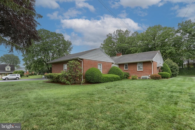 228 S Forge Rd, Palmyra, PA 17078 - view of home's exterior with brick siding, cooling unit, and a yard