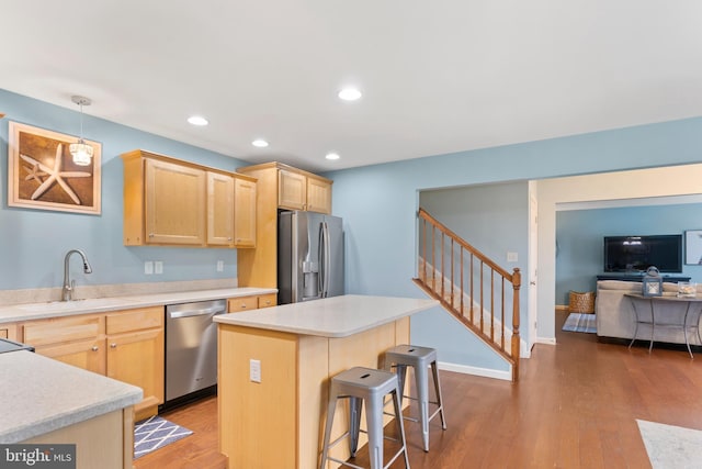 1900 Preserve Ln, Palmyra, PA 17078 - kitchen with stainless steel appliances, light brown cabinetry, light countertops, a kitchen bar, and recessed lighting