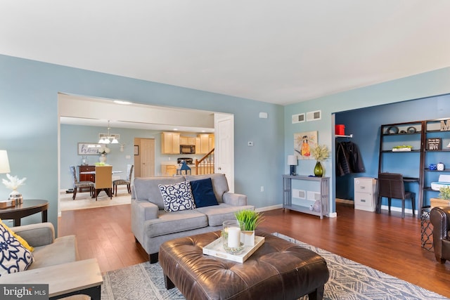 1900 Preserve Ln, Palmyra, PA 17078 - living room with wood finished floors, stairway, and a chandelier
