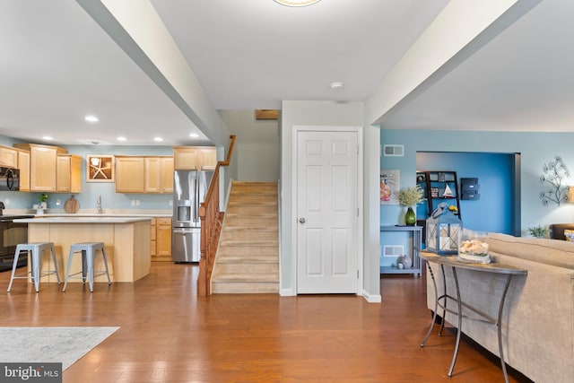 1900 Preserve Ln, Palmyra, PA 17078 - kitchen featuring black appliances, light brown cabinetry, open floor plan, dark wood-style flooring, and light countertops