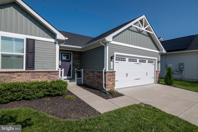 189 Massie St, Stephens City, VA 22655 - view of front of house with board and batten siding, stone siding, a garage, and concrete driveway