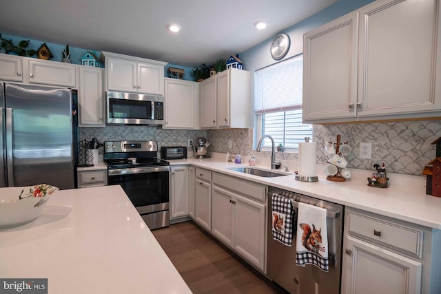 189 Massie St, Stephens City, VA 22655 - kitchen featuring appliances with stainless steel finishes, a sink, light countertops, dark wood-style floors, and tasteful backsplash