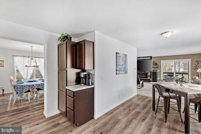 228 Cranberry Dr, Blakeslee, PA 18610 - dining space featuring light wood-style flooring, a chandelier, and baseboards