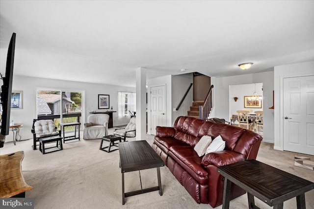 228 Cranberry Dr, Blakeslee, PA 18610 - living room featuring light carpet, stairway, and a chandelier