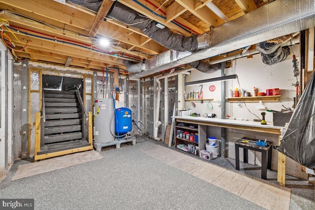 228 Cranberry Dr, Blakeslee, PA 18610 - unfinished below grade area featuring water heater, a water pressure tank, and stairs