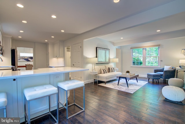 12013 Cheviot Dr, Herndon, VA 20170 - kitchen with open floor plan, white cabinetry, light countertops, a peninsula, and a kitchen breakfast bar