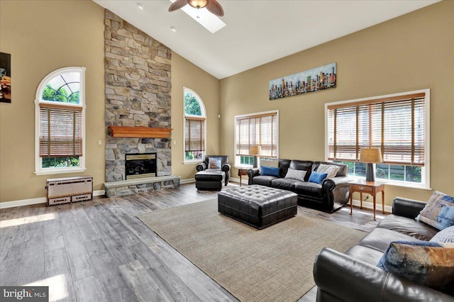 17 N Carolina Ave, Reading, PA 19608 - living room featuring high vaulted ceiling, a ceiling fan, baseboards, wood finished floors, and a fireplace