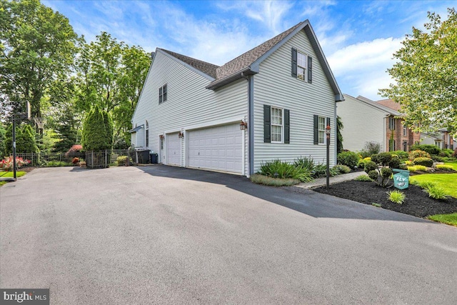 17 N Carolina Ave, Reading, PA 19608 - view of side of property with driveway, an attached garage, and a shingled roof