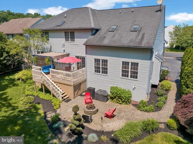 17 N Carolina Ave, Reading, PA 19608 - back of house featuring a fire pit, a deck, a patio, a shingled roof, and stairway